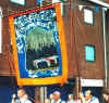 Banner of LOL 979 depicting Sir Edward Carson signing the Ulster Covenant in 1912.